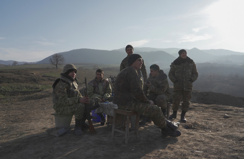 Ethnic Armenian soldiers gather at their fighting positions near the village of Taghavard in the region of Nagorno-Karabakh, January 11, 2021. (credit: REUTERS/ARTEM MIKRYUKOV)