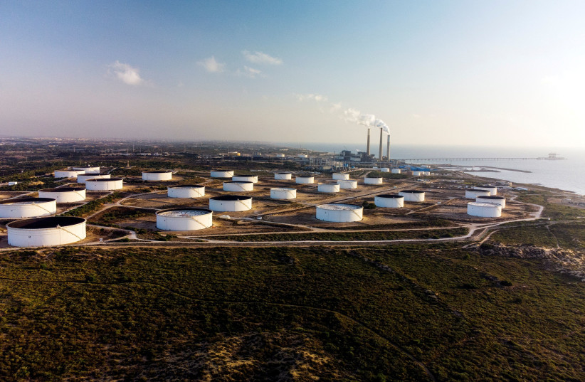 An aerial view shows storage tanks at the oil terminal of Europe Asia Pipeline Company (EAPC) off the Mediterranean coast in Ashkelon, Israel June 10, 2021. (photo credit: REUTERS/AMIR COHEN/FILE PHOTO)