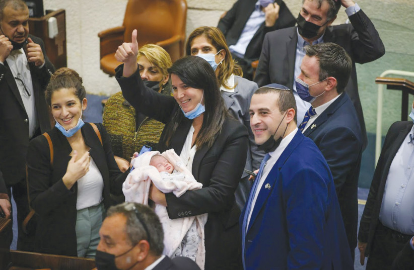 MK Shirley Pinto brings her six-day-old baby to the Knesset Wednesday, enabling her to take part in a vote. (credit: NOAM MOSKOVICH/KNESSET)