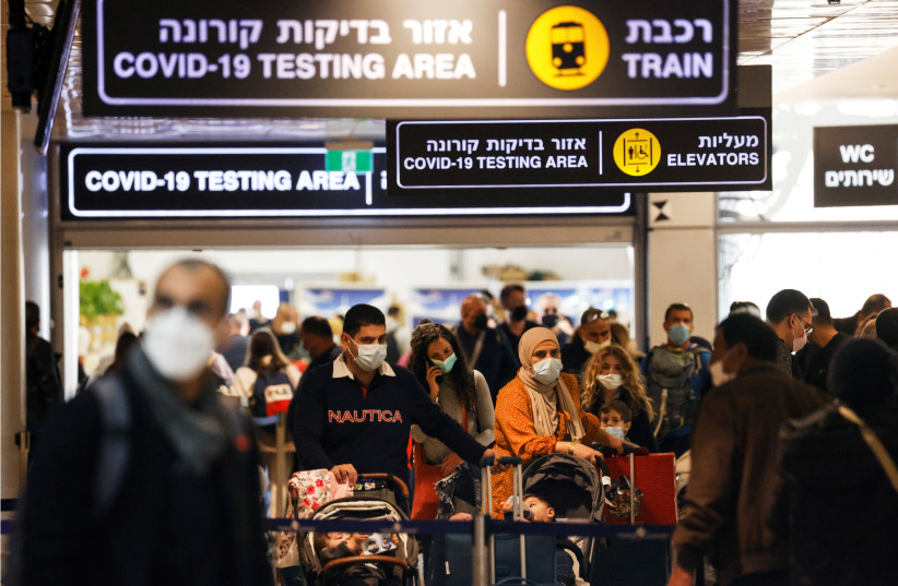  Travelers exit the coronavirus disease (COVID-19) pandemic testing area at Ben Gurion International Airport as Israel imposes new restrictions on November 28, 2021. (credit: AMIR COHEN/REUTERS)