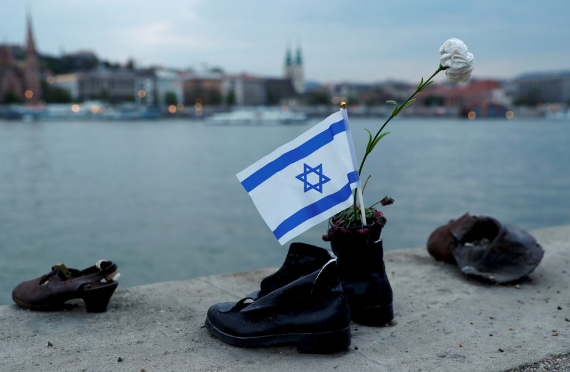  Israeli flag is seen attached to ''Shoes on the Danube Bank'' memorial during the annual ''March of the Living'' to commemorate victims of the Holocaust (credit: REUTERS/BERNADETT SZABO)