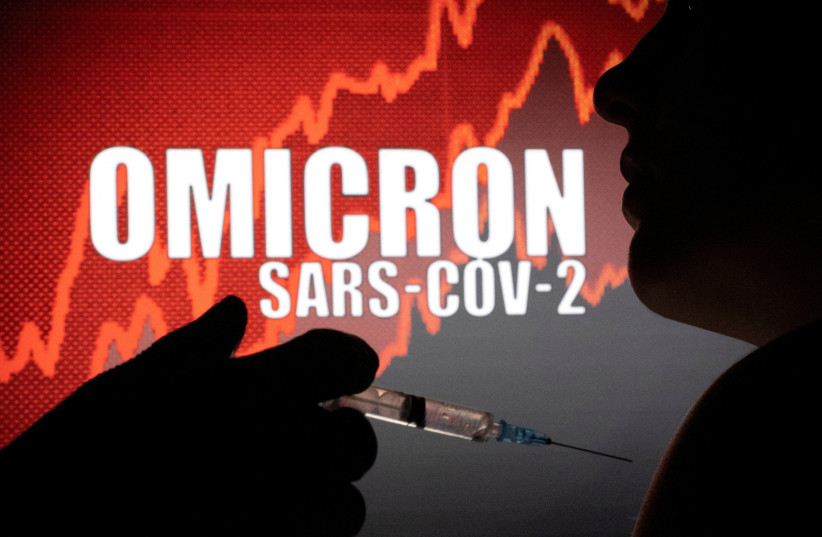  People pose with syringe with needle in front of displayed words "OMICRON SARS-COV-2" in this illustration taken, December 11, 2021 (photo credit: REUTERS/DADO RUVIC/ILLUSTRATION/FILE PHOTO)