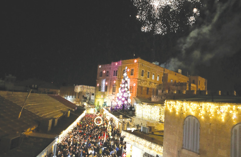  FIREWORKS EXPLODE during last week’s Christmas tree lighting ceremony in Jerusalem’s Old City. (photo credit: AMMAR AWAD/REUTERS)