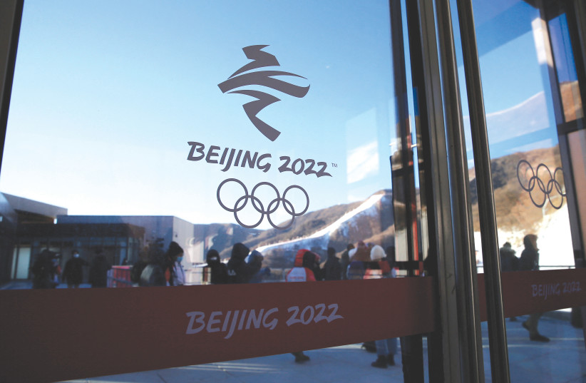  THE EMBLEM OF the Beijing 2022 Winter Olympics is seen on a glass door at the National Alpine Skiing Center in the Chinese capital, last week. (photo credit: TINGSHU WANG/REUTERS)