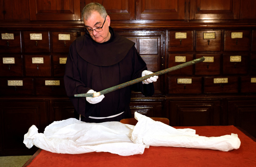  Father Stephane, Franciscan Friar and Liturgist of the Custody of the Holy Land holds an organ pipe, part of a collection from the 12th century that researchers say used to play music inside Bethlehem's Church of the Nativity and was hidden together with bells by Crusaders. (photo credit: AMIR COHEN/REUTERS)