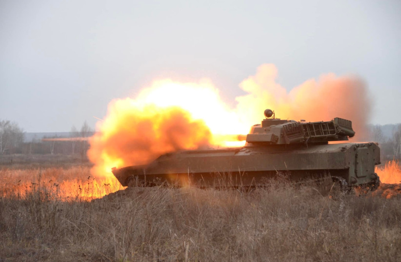 A self-propelled howitzer fires during artillery drills held by the 92nd Separate Mechanized Brigade of the Ukrainian Armed Forces at a shooting range in an unknown location in eastern Ukraine, in this handout picture released December 17, 2021. (photo credit: PRESS SERVICE OF THE 92ND SEPARATE MECHANIZED BRIGADE/HANDOUT VIA REUTERS)