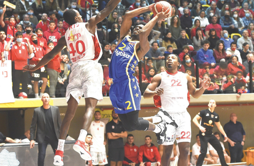  KEENAN EVANS (with ball) and Maccabi Tel Aviv had their hands full against Hapoel Galil Elyon, but the yellow-and-blue was able to pull out an 88-84 overtime victory. (photo credit: BERNEY ARDOV)