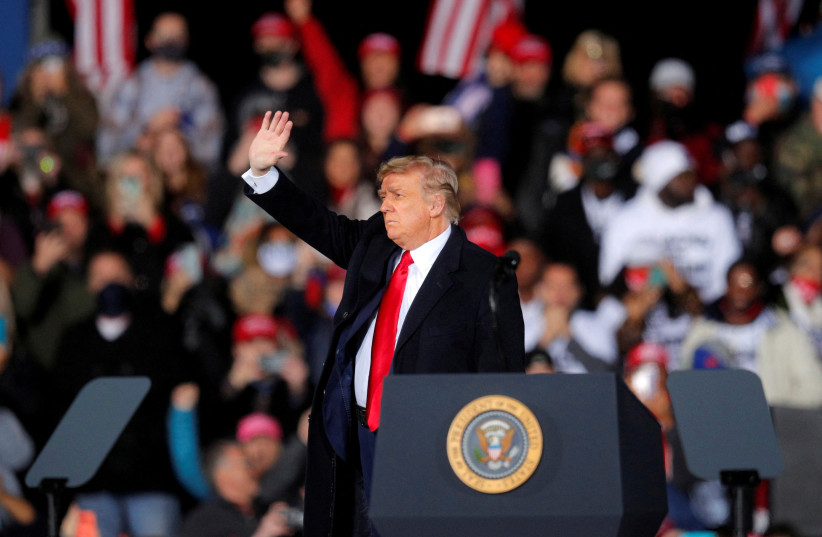 US President Donald Trump waves at a campaign for Republican Senator Kelly Loeffler on the eve of the run-off election to decide both of Georgia's Senate seats, in Dalton, Georgia, US, January 4, 2021. (photo credit: REUTERS/BRIAN SNYDER/FILE PHOTO)