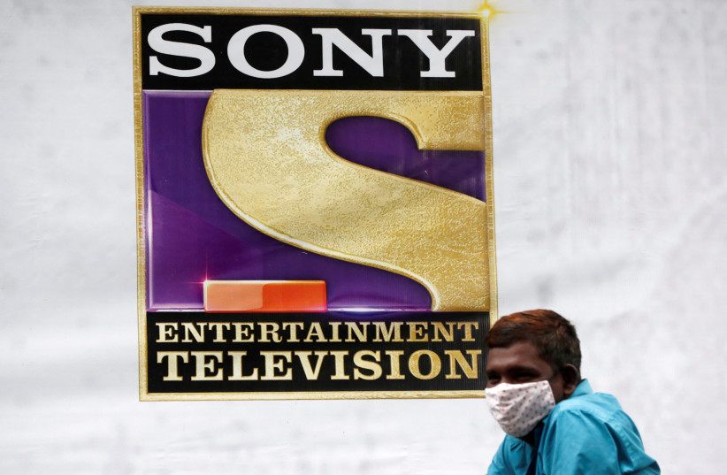  A man stands next to a banner of Sony Entertainment, outside a film set in Mumbai, India, September 24, 2021. (photo credit: REUTERS/FRANCIS MASCARENHAS)