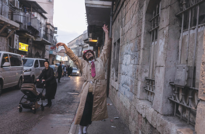  A YOUNG hassid lets his hair down on Purim.  (credit: PAVEL WOLBERG)