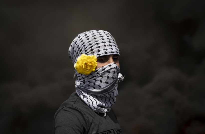  A PALESTINIAN youth is caught in a contrasting getup during clashes with IDF soldiers. (credit: OREN ZIV)