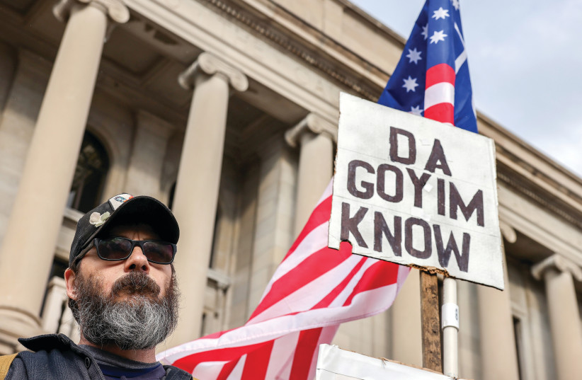  A WHITE SUPREMACIST protester holds an antisemitic sign outside the Kenosha County Courthouse during jury deliberations in the Kyle Rittenhouse trial, in Kenosha, Wisconsin, last month. (credit: EVELYN HOCKSTEIN/REUTERS)