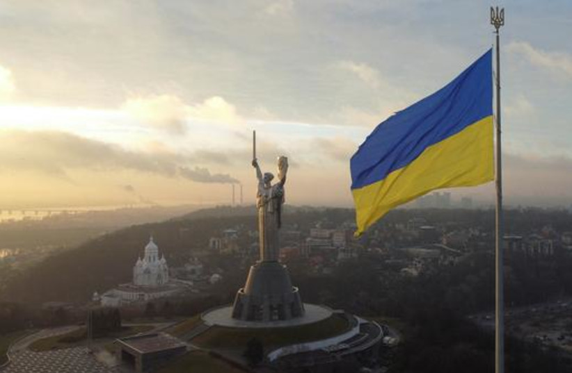  Ukraine's biggest national flag on the country's highest flagpole and the giant 'Motherland' monument (photo credit: REUTERS/VALENTYN OGIRENKO)
