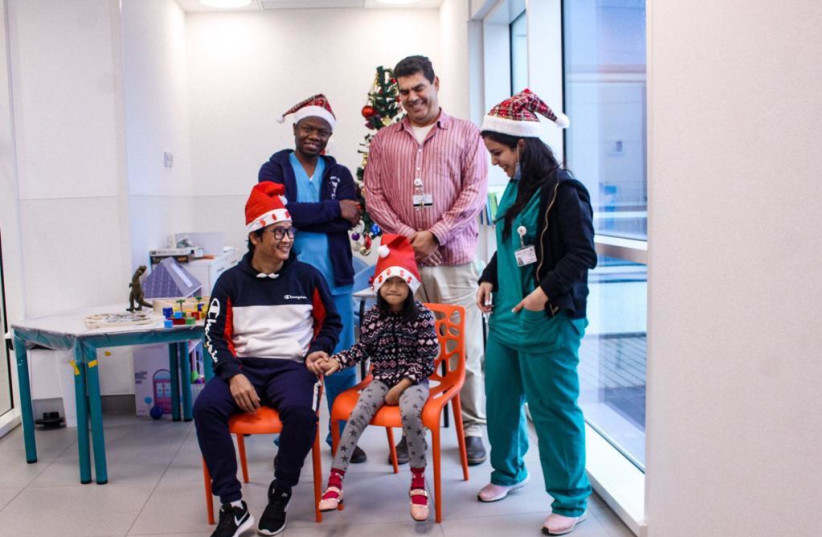  Physicians from three religious backgrounds came together to wish little Hannah a “Merry Christmas” at the Sylvan Adams Childress Hospital in Holon. (photo credit: SAVE A CHILD'S HEART)