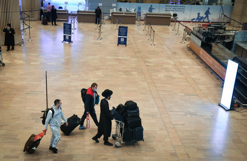   Travelers seen at the Ben Gurion International Airport, on December 22, 2021. (photo credit: FLASH90)