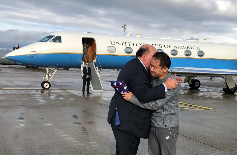 Xiyue Wang hugging United States Ambassador to Switzerland and Liechtenstein Ed McMullen in December 2019 following his release from Iranian prison. (photo credit: Wikimedia Commons)