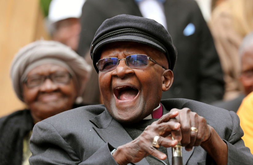  Archbishop Desmond Tutu laughs as crowds gather to celebrate his birthday by unveiling an arch in his honour outside St George's Cathedral in Cape Town, South Africa, October 7, 2017. (photo credit: REUTERS/MIKE HUTCHINGS)