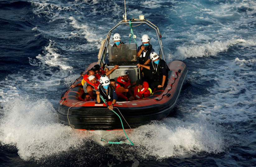  A RHIB (rigid hulled inflatable boat) from the German NGO migrant rescue ship Sea-Watch 3 returns to the ship after rescuing twelve migrants from a wooden boat in international waters north of Libya, in the western Mediterranean Sea, August 2, 2021. (photo credit: DARRIN ZAMMIT LUPI/REUTERS)
