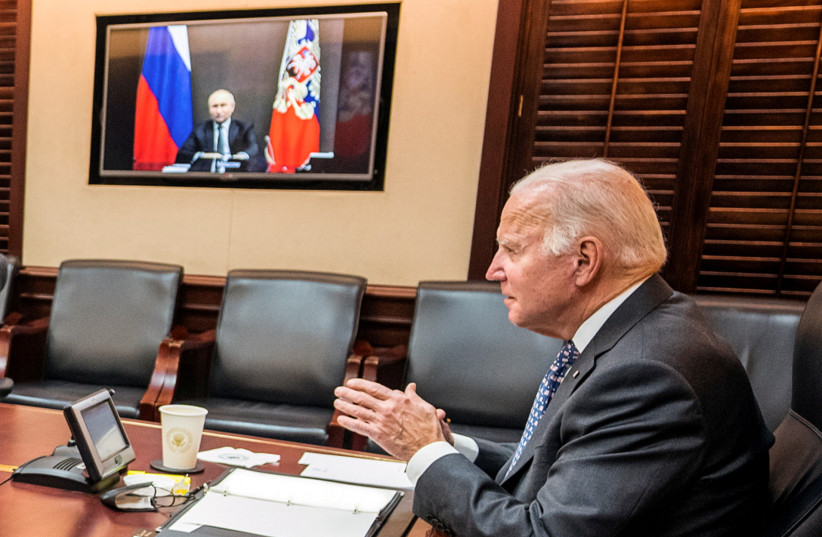 US President Joe Biden holds virtual talks with Russia's President Vladimir Putin amid Western fears that Moscow plans to attack Ukraine, during a secure video call from the Situation Room at the White House in Washington, US, December 7, 2021. (photo credit: The White House/Handout via REUTERS)