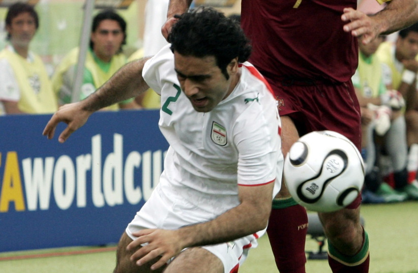  Iran's Mehdi Mahdavikia in action against Portugal's Luis Figo (photo credit: ACTION IMAGES / LEE SMITH VIA REUTERS)