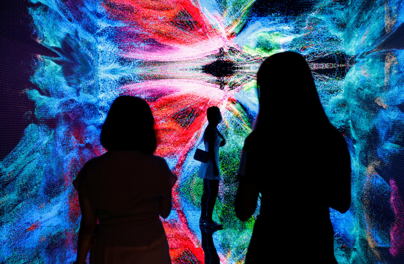  Visitors are pictured in front of an art installation which will be converted into NFT and auctioned online at Sotheby's, in Hong Kong (credit: REUTERS/TYRONE SIU)