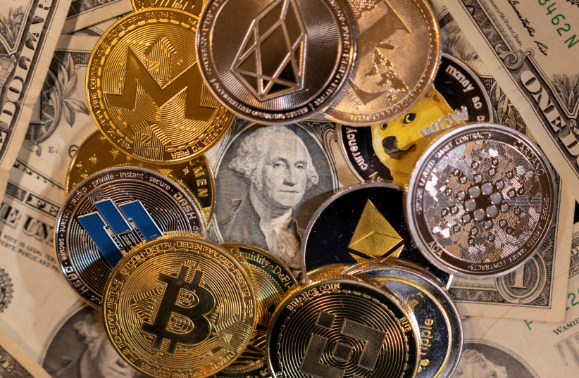  Representations of virtual cryptocurrencies are placed on U.S. Dollar banknotes in this illustration taken November 28, 2021. (photo credit: REUTERS/DADO RUVIC/ILLUSTRATION/FILE PHOTO)