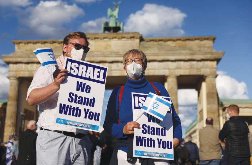  DEMONSTRATORS RALLY in solidarity with Israel and against antisemitism, in front of the Brandenburg Gate in Berlin, in May. (photo credit: Christian Mang/Reuters)