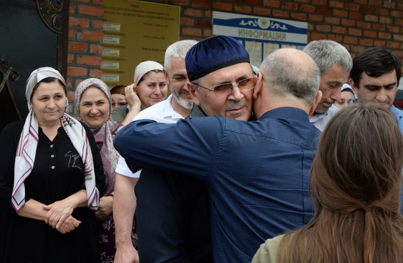 Oyub Titiev, the head of the Chechen office of the Memorial Human Rights Centre, is welcomed after his release, outside of a penal colony settlement, in the town of Argun, in Chechnya, Russia, June 21, 2019. (photo credit: REUTERS/SAID TSARNAYEV)