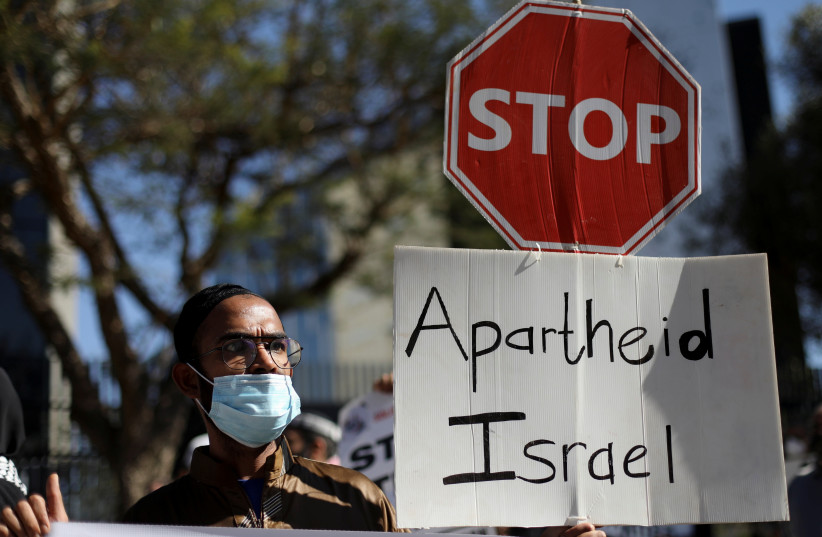  South African demonstrators and BDS activists hold placards during a protest in May 2021 outside the Israel Trade offices in Sandton, SA, following a flare-up of Israeli-Palestinian violence (photo credit: SIPHIWE SIBEKO/REUTERS)