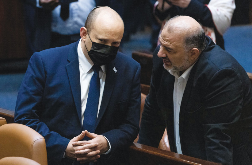  PRIME MINISTER Naftali Bennett and Ra’am Chairman Mansour Abbas confer in the Knesset last month. (credit: YONATAN SINDEL/FLASH90)