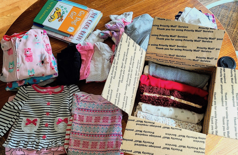  A package of gently used clothing and books is intended for a refugee family matched with a volunteer from the New Neighbors Partnership, a New York-based nonprofit.  (photo credit: Courtesy New Neighbors Partnership)