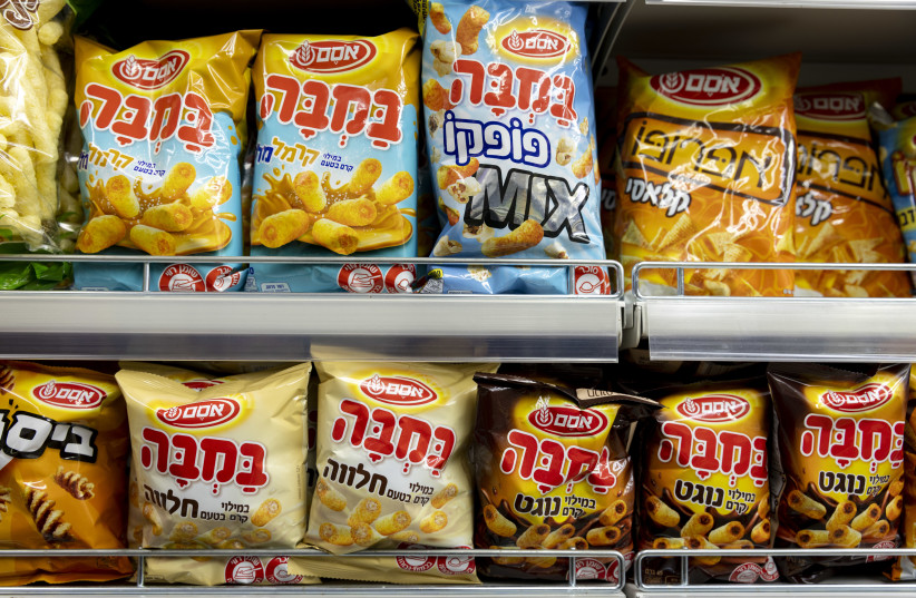 Packages of Bamba - made by Osem - on a shelf in a Jerusalem grocery store on December 29, 2021. (photo credit: OLIVIER FITOUSSI/FLASH90)