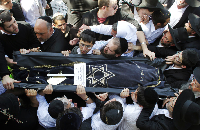 Carrying the body of Miriam Monsonego during a joint Jerusalem funeral for four victims of the 2012 terror murders in Toulouse, France (photo credit: NIR ELIAS/REUTERS)
