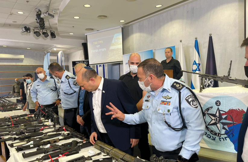  PRIME MINISTER Naftali Bennett and Police commissioner Kobi Shabtai examine rifles caught during Operation Ocean last month. (photo credit: ISRAEL POLICE)
