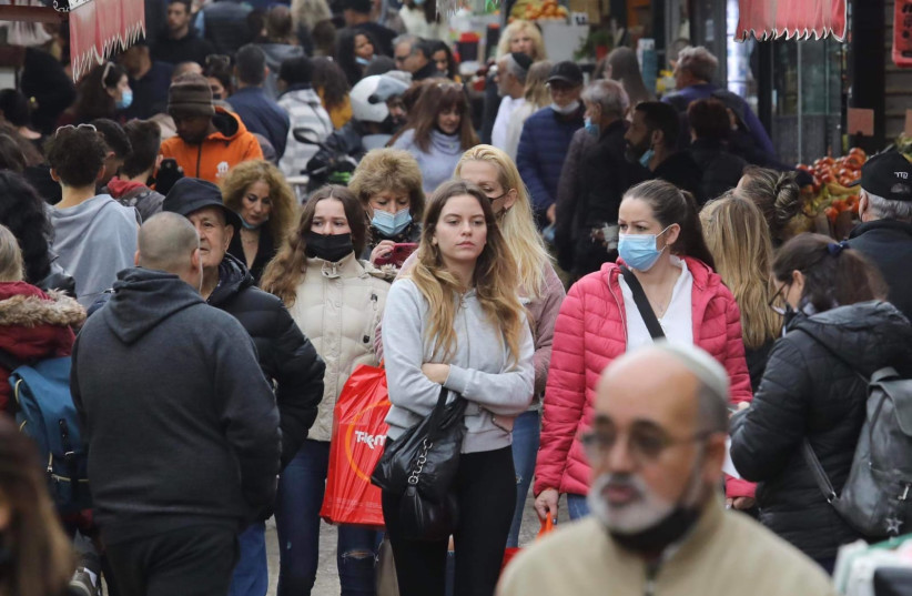  People walk, some with face masks, in Tel Aviv (credit: MARC ISRAEL SELLEM/THE JERUSALEM POST)