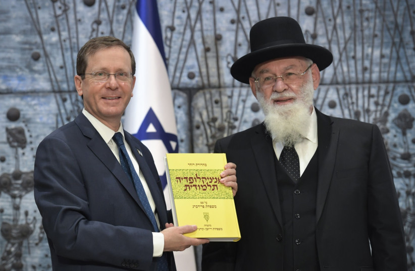  PRESIDENT ISAAC HERZOG with the latest volume of the Talmudic Encyclopedia presented to him by Prof. Rabbi Avraham Steinberg, head of Yad HaRav Herzog. (photo credit: KOBI GIDEON/GPO)