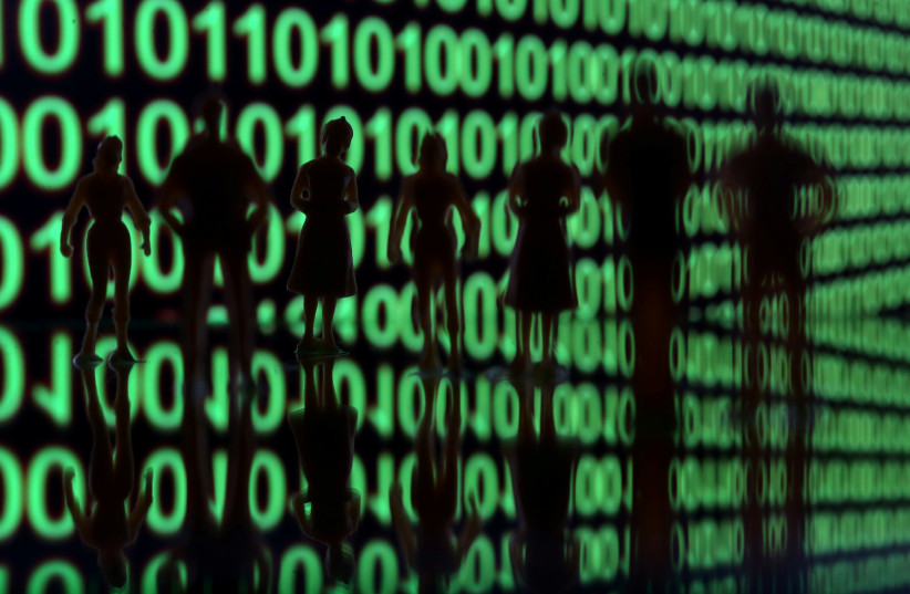  Small toy figures are seen in front of a binary code in this illustration picture, April 8, 2019.  (photo credit: REUTERS/DADO RUVIC/ILLUSTRATION)