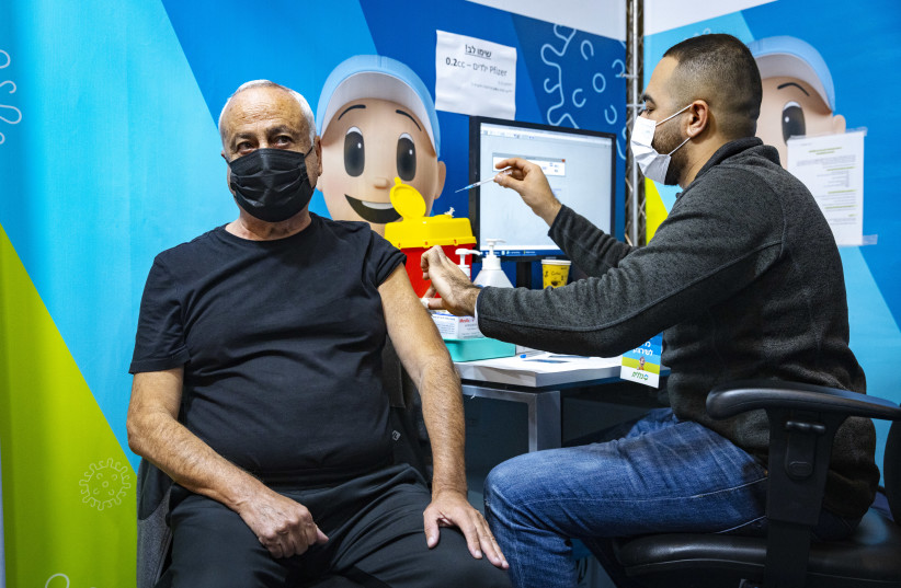  Adults over the age of 60 receive a 4th dose of the COVID-19 vaccine, at a Clallit vaccine center in Jerusalem on January 3, 2022.  (credit: OLIVIER FITOUSSI/FLASH90)
