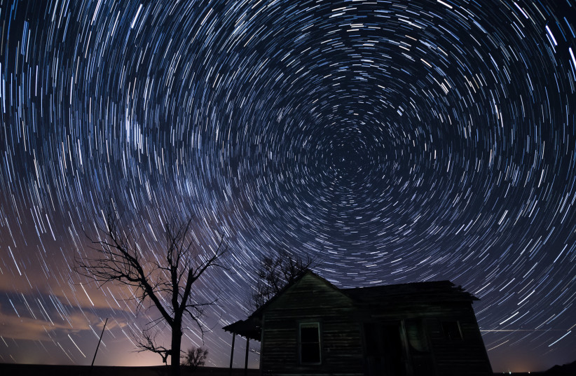  The Quadrantids meteor shower is seen above a home in Colorado in 2014. (photo credit: Shannon Dizmang/Flickr)