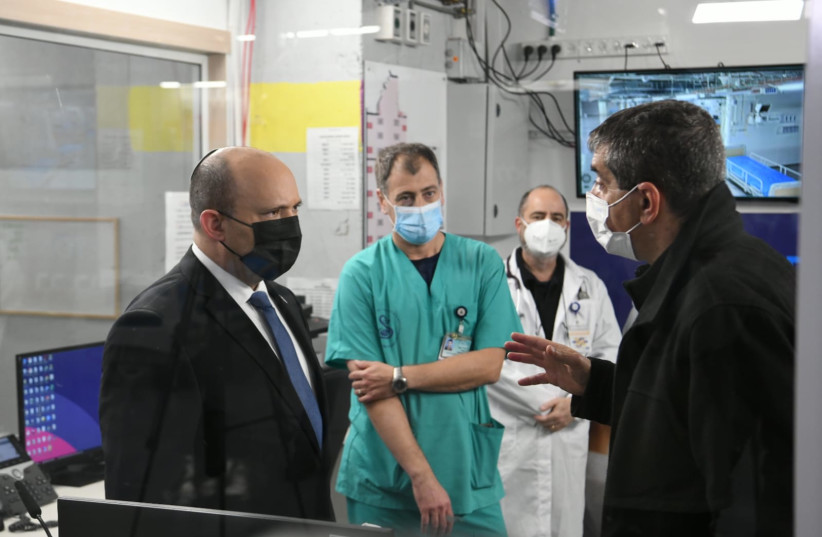  Prime Minister Naftali Bennett visiting Sheba Medical Center as COVID-19 Omicron cases soar in Israel, taken January 4, 2022 (credit: AMOS BEN-GERSHOM/GPO)