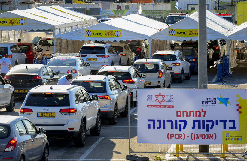 Cars line up at a drive-through COVID-19 testing center in Ganey Taaruha Tel Aviv, on January 3, 2022.  (photo credit: AVSHALOM SASSONI/FLASH90)