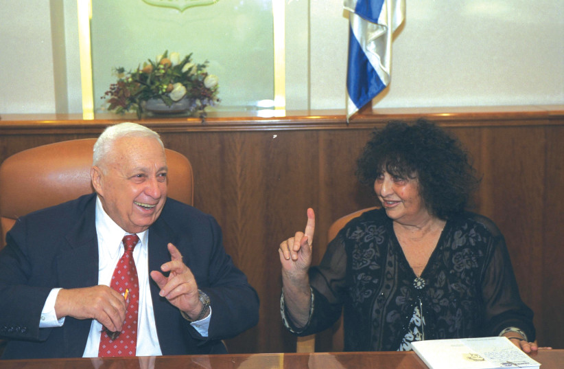  LATE FORMER MK Geula Cohen presents then prime minister Ariel Sharon with an illustrated poem book by Uri Zvi Greenberg in 2002.  (credit: Avi Ohayon/GPO)