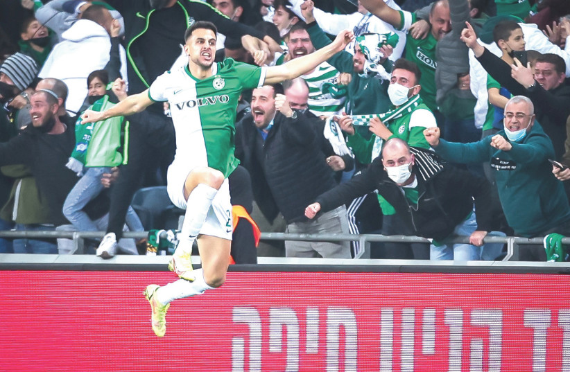  MACCABI HAIFA forward Dean David celebrates after scoring the game-winning goal in the Greens’ 3-2 comeback victory over Maccabi Tel Aviv on Monday night.  (credit: MAOR ELKASLASI)