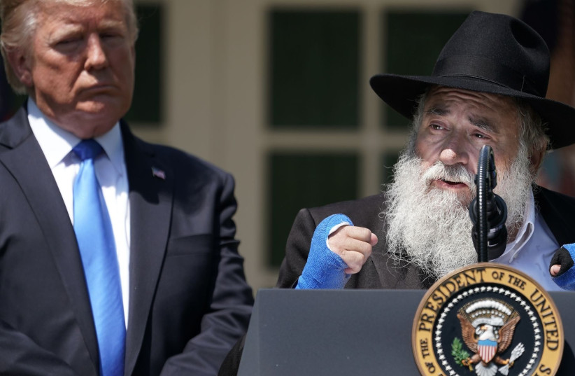  U.S. President Donald Trump (L) listens to Congregation Chabad Rabbi Yisroel Goldstein of Poway, California, speak during a National Day of Prayer service in the Rose Garden at the White House in Washington, DC on May 02, 2019.  (photo credit: CHIP SOMODEVILLA/GETTY IMAGES/JTA)