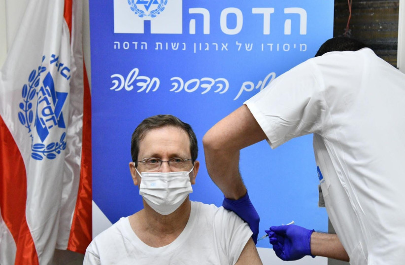  Israel's President Isaac Herzog is seen receiving his fourth COVID-19 vaccine dose at Hadassah-University Medical Center in Jerusalem's Ein Kerem, on January 5, 2021. (credit: HAIM ZACH/GPO)