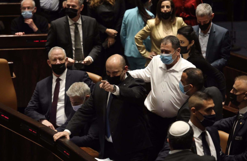  Prime Minister Naftali Bennett points at opposition members amid squabble in Knesset plenum, January 5, 2022 (photo credit: MARC ISRAEL SELLEM)