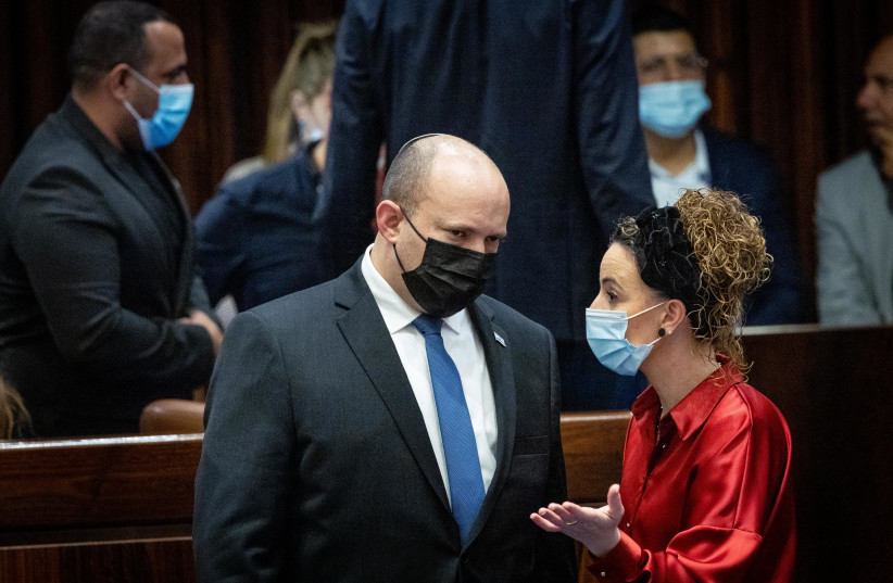  Israeli prime minister Naftali Bennett speaks with MK Idit Silman a discussion on the Electricity Law connecting to Arab and Bedouin towns, during a plenum session in the assembly hall of the Israeli parliament in Jerusalem, January 5, 2022.  (credit: YONATAN SINDEL/FLASH90)