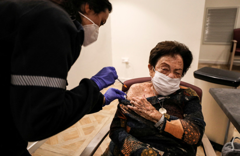 Senior citizens receive a fourth dose of the COVID-19 vaccine at a vaccination party in Netanya (photo credit: REUTERS/AMMAR AWAD)
