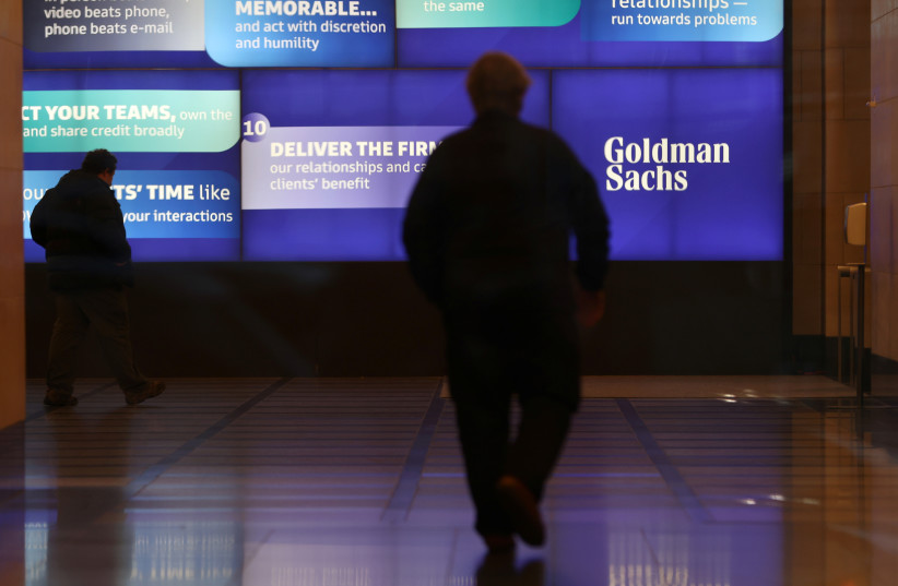  People walk in the Goldman Sachs global headquarters in Manhattan, New York, U.S., November 15, 2021.  (credit: REUTERS/ANDREW KELLY)