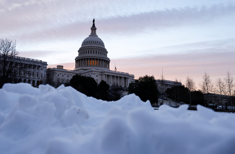 The US Capitol is seen at sunrise on the first anniversary of the January 6, 2021 attack on the Capitol by supporters of former President Donald Trump, on Capitol Hill in Washington, US, January 6, 2022. (photo credit: REUTERS/JONATHAN ERNST)